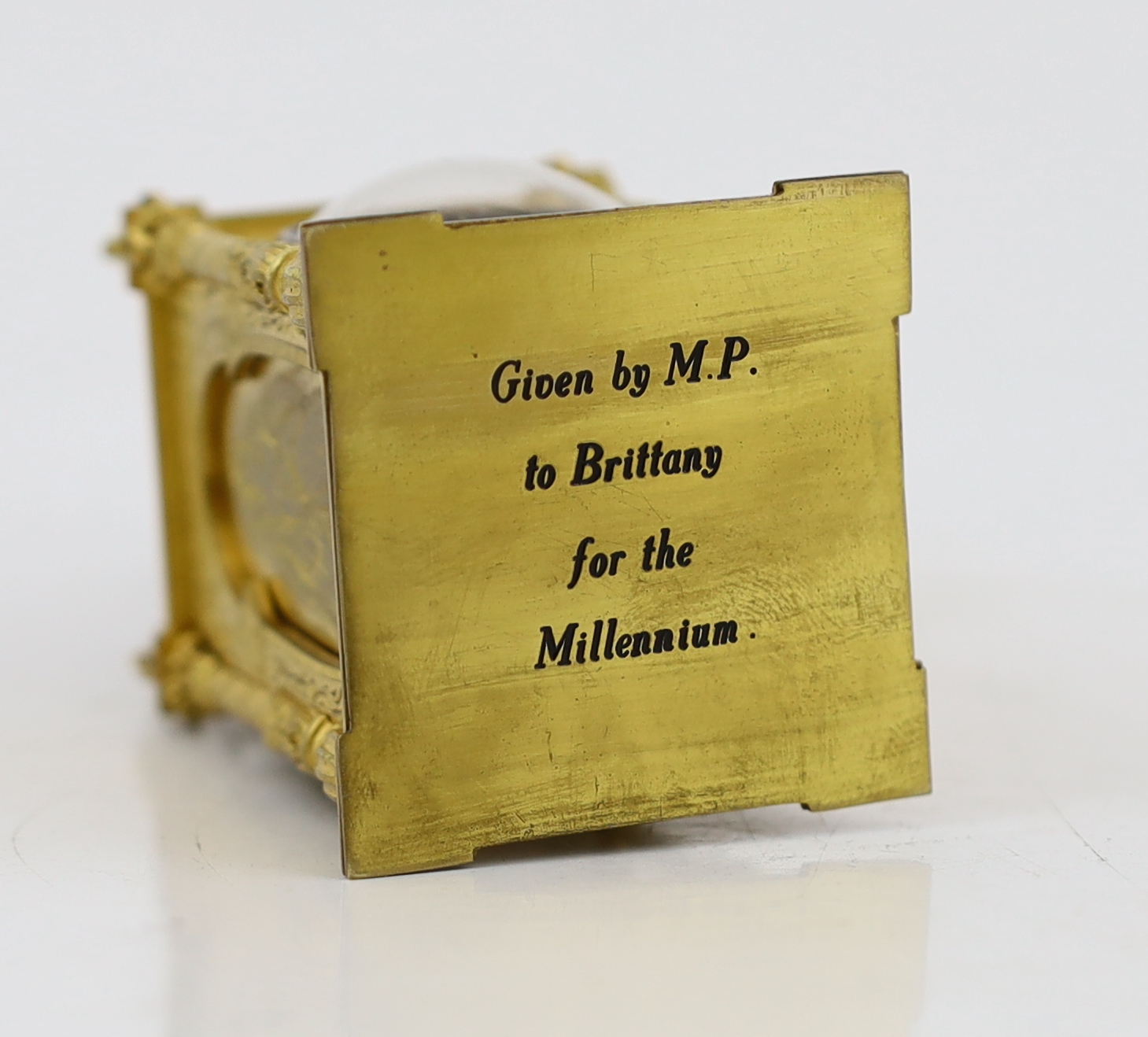 An early 20th century French miniature timepiece modelled on a 17th century domed bell clock, 4.75cm wide, 9.5cm high, with original leather travelling case